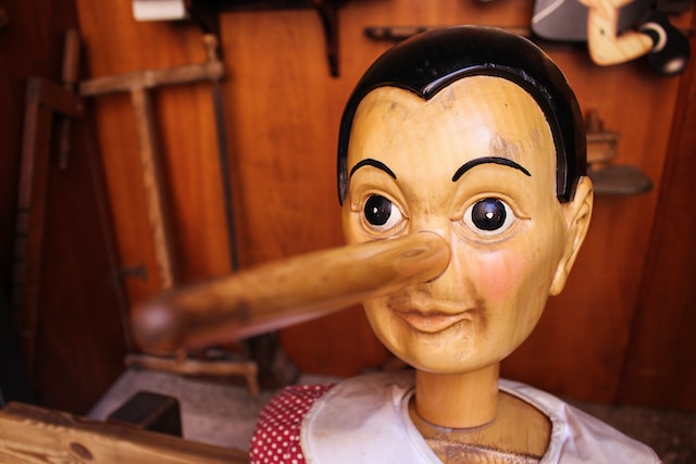 Wooden doll with a long nose representing a liar